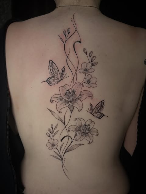Floral and butterfly spine piece by Savanna Blair